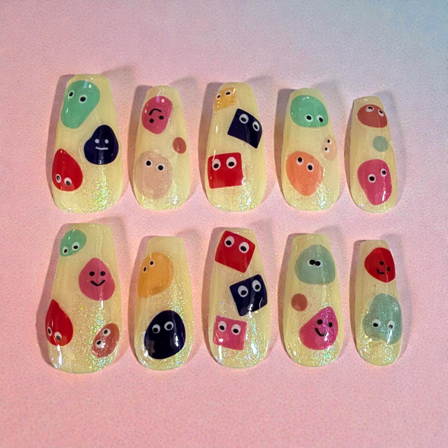 Glitter yellow coffin nails with cartoon faces