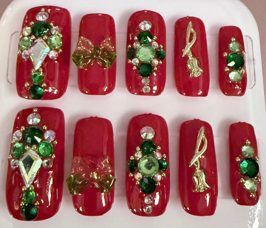 Red square shaped nails with handset gems