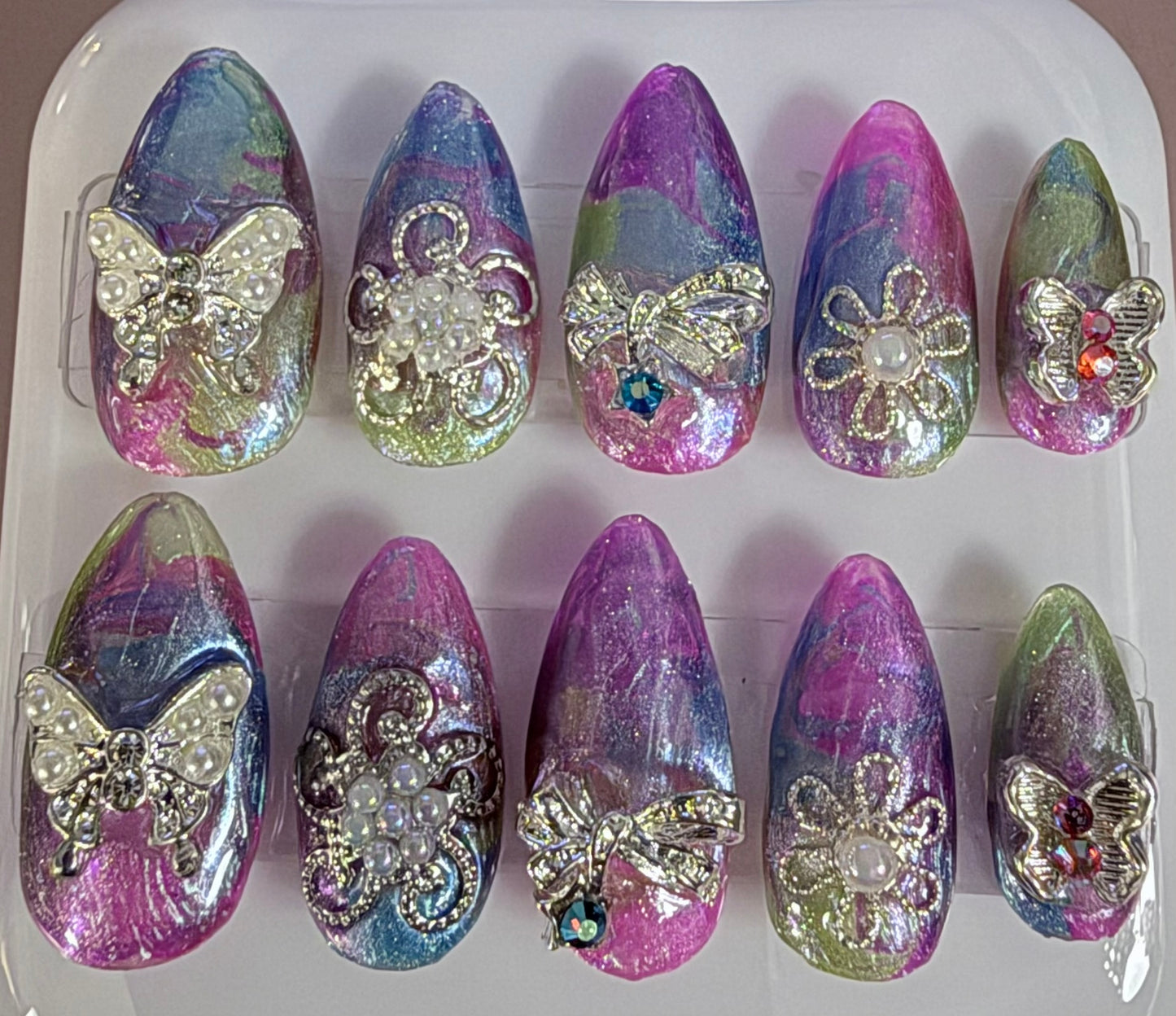 Multi colored almond nails with metal flowers and butterflies
